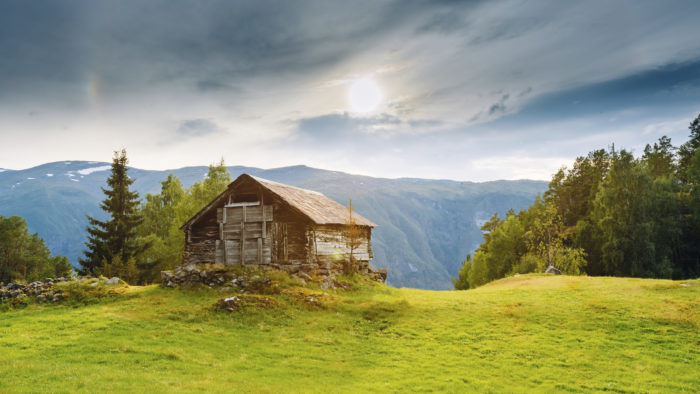 Old abandoned wooden house on a background of the Norwegian moun